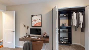 a bedroom with a desk and a closet